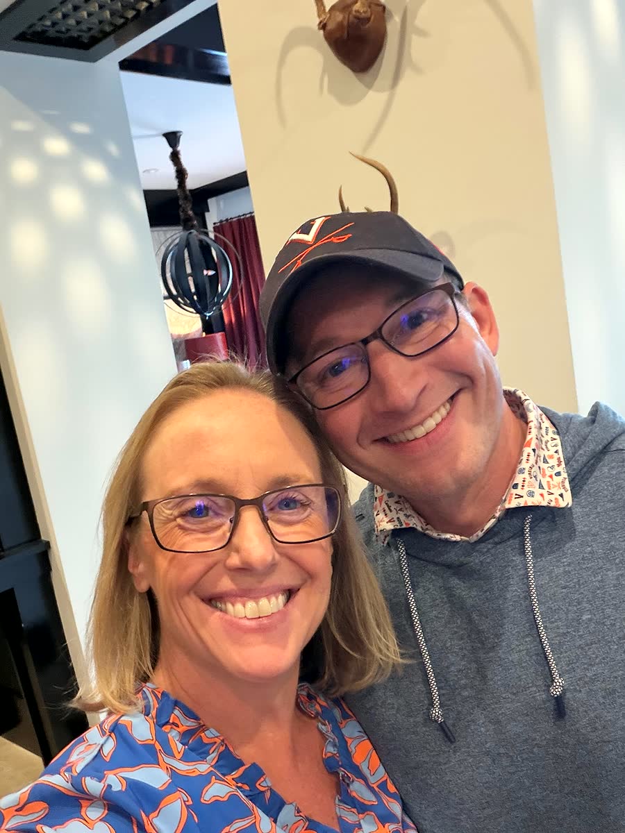 Ben, in glasses and a navy UVA cap, leans in for a selfie with Nicole.