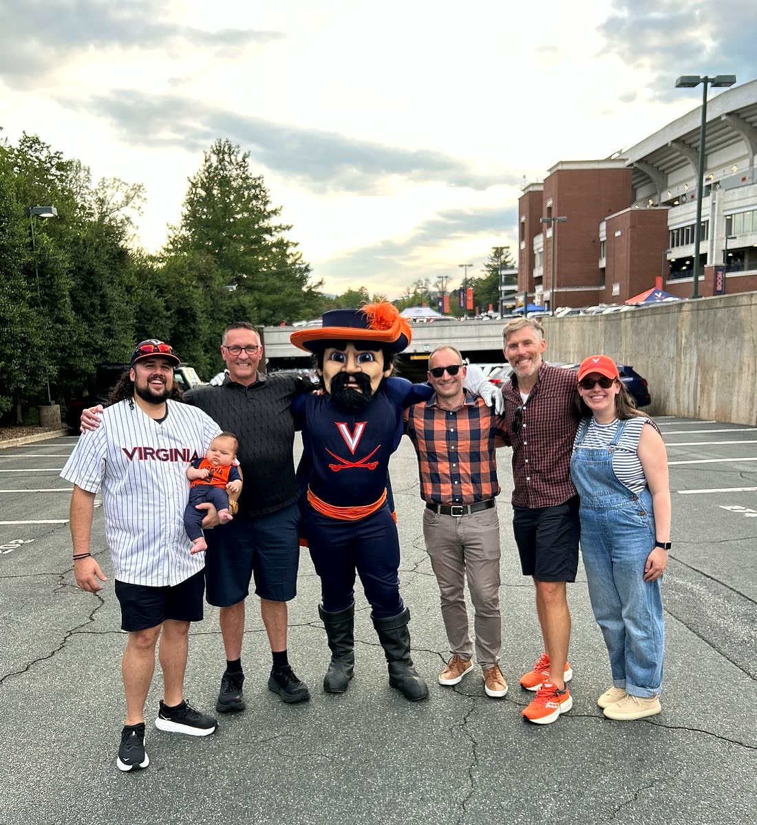 Our tailgate group posing with the Cavman mascot in the lot outside Scott Stadium.